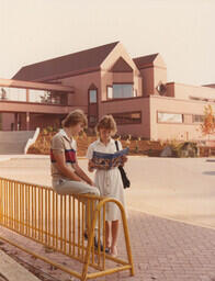 Students posing for a publicity shoot, holding the 1983/84 Fraser Valley College calendar, on the brand new Abbotsford campus on King Road. Dale Weir and Noelle Bourget