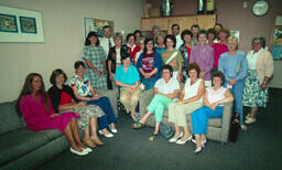 Chilliwack campus staff gather at party for Public Information Office assistant Nina Racine. On the couch to the left: Julie Williams, Sybille Stegmueller, Shelley Hayes. Standing between couches: Diane Nosaty, Bill Cooke, Marlys Southwell, Jean Williams,