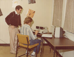Student working on early Apple computer