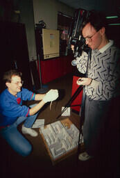 Students using audio visual equipment, and preparing to drop a rodent into a maze.