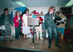 Cheryl Isaac in front of Continuing Education colleagues at Frank Dolman's retirement