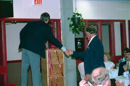 Harv McCullough, director of trades (with back to camera) and Frank Dolman at Frank's retirement party.