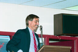 Barry Bompas, director of employee relations, at the podium at Frank Dolman's retirement party.