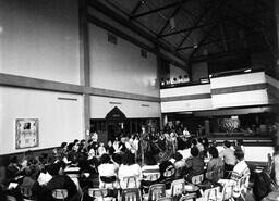 Fashion show featuring work of students in the Fashion Design program. View of the audience in the Great Hall in Building A (now known as Alumni Hall in Building B).