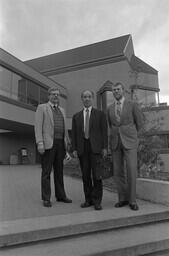Registrar Bill Cooke (right) with two unidentified men.