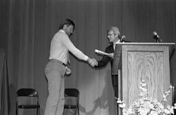 Dean Erling Close (right) congratulates a student at awards ceremony.